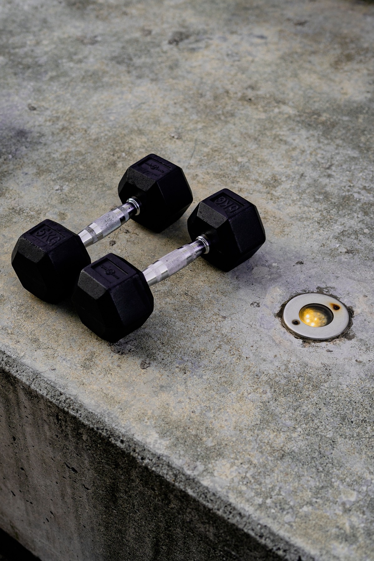 Pair of hex dumbbells resting on a concrete ledge